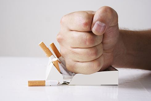Man crushing cigarettes