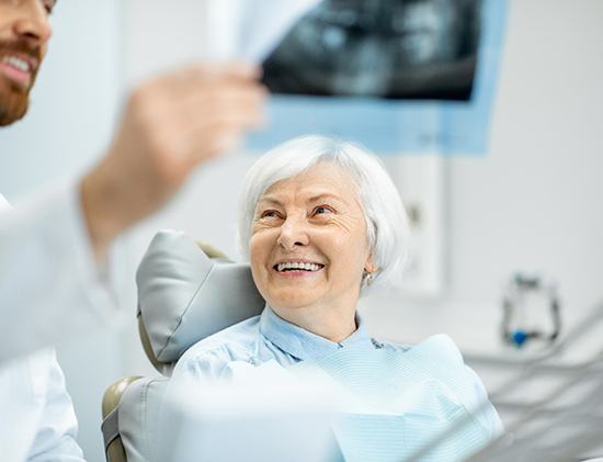 patient smiling while looking at dentist