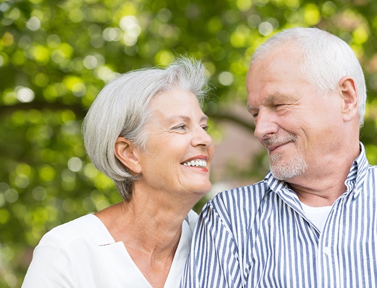 older couple smiling and looking at each other 