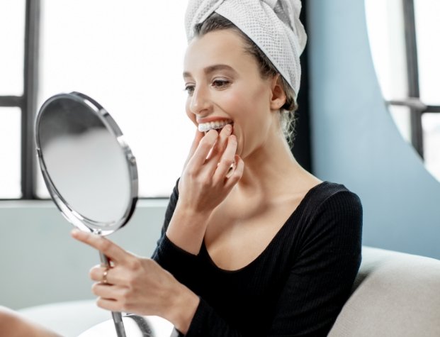 Woman using take home teeth whitening kit